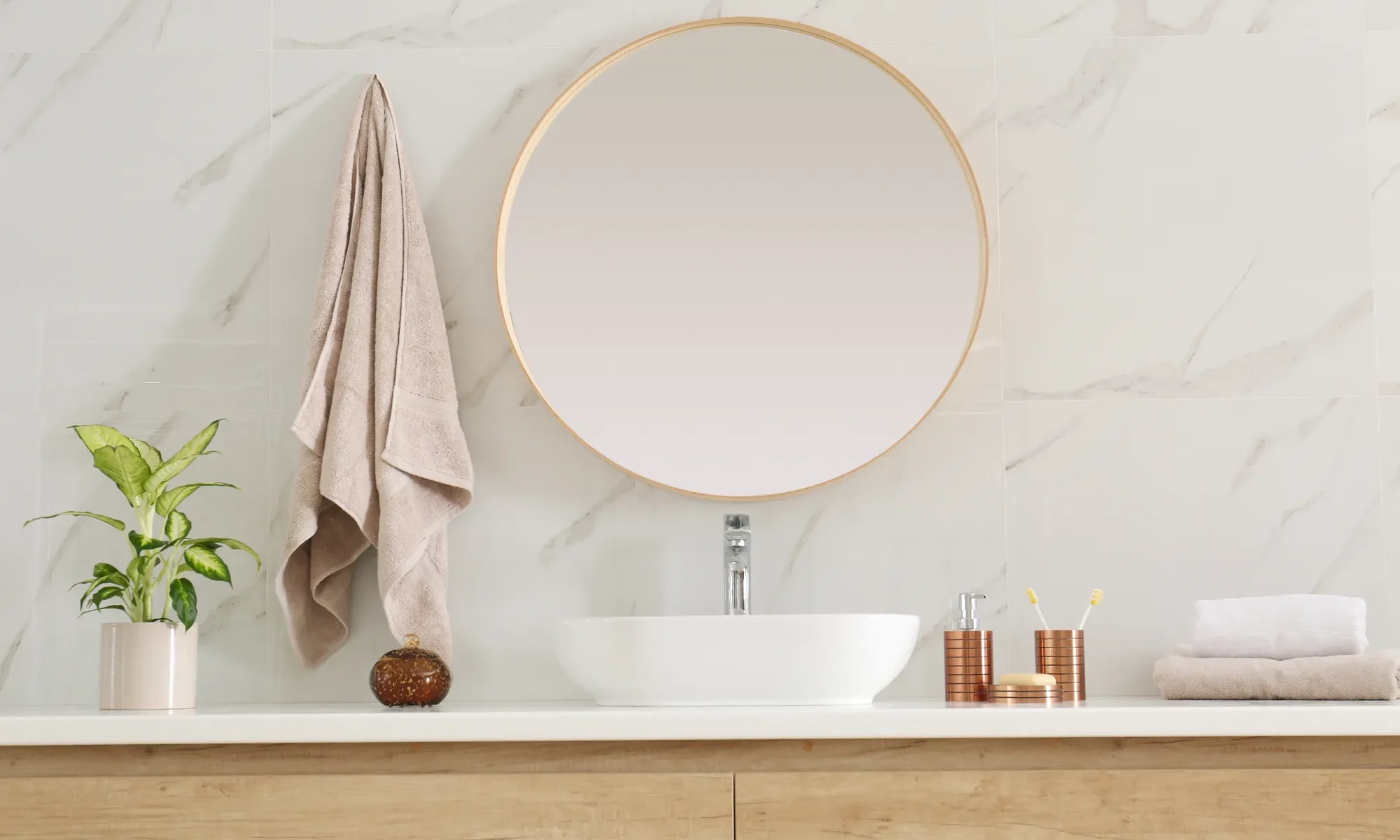 Modern bathroom vanity with vessel sink, round mirror and marble-look wall, bathroom remodeling